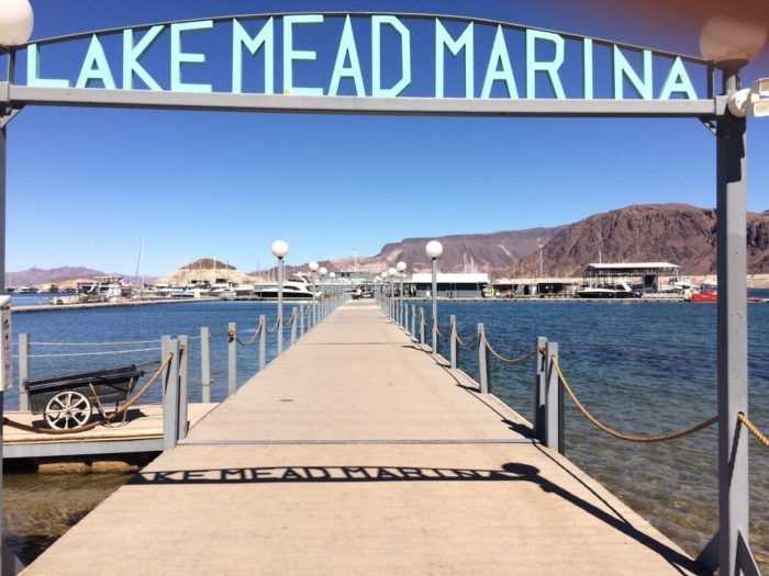 Lake Mead Marina sign at the start of the Horsepower Cove platform in Hemenway Harbor, Lake Mead National Recreation Area, Nevada. This sign marks the way to the Harbor House Cafe, boat rentals, and the marina store